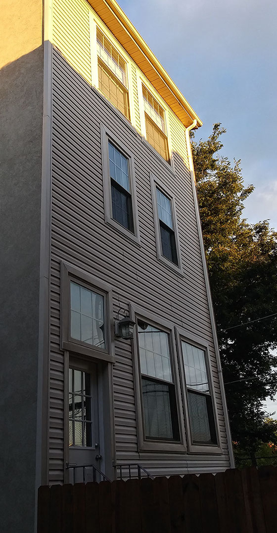 stucco replaced. completed vinyl siding job on rear of home